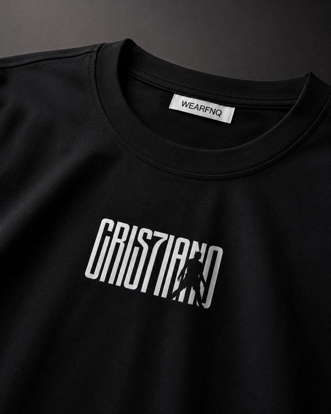 Black t-shirt with white logo and 'WEARFNQ' label on a dark background